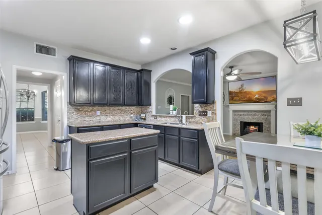 a kitchen with a sink cabinets and stainless steel appliances