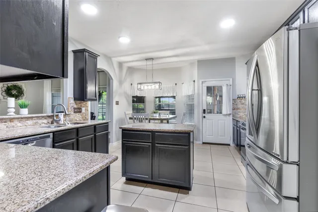 a kitchen with a refrigerator sink and stove