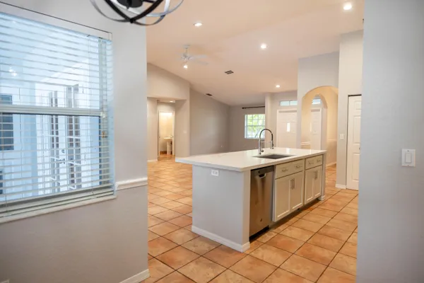 a kitchen with stainless steel appliances granite countertop a sink and a stove