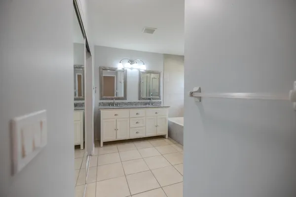 a bathroom with a mirror sink and vanity