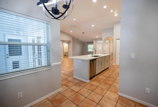 a large kitchen with stainless steel appliances a large counter top and a stove