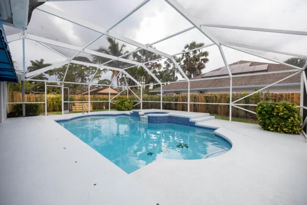 a view of a swimming pool with a yard in back