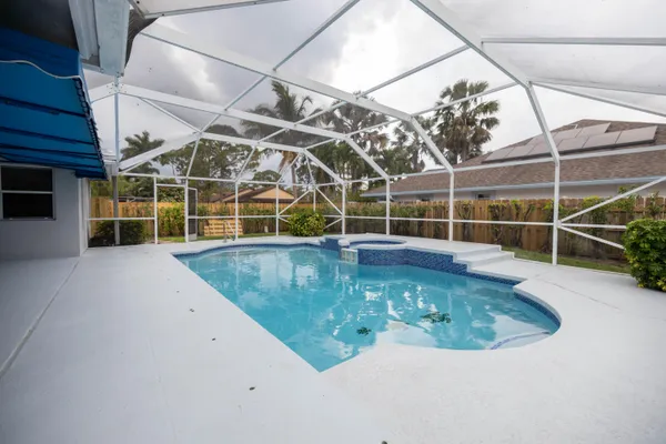 a view of a swimming pool with a yard