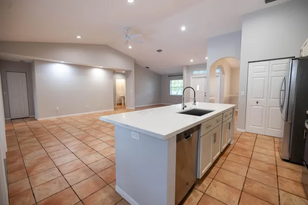 a kitchen with a sink and a refrigerator