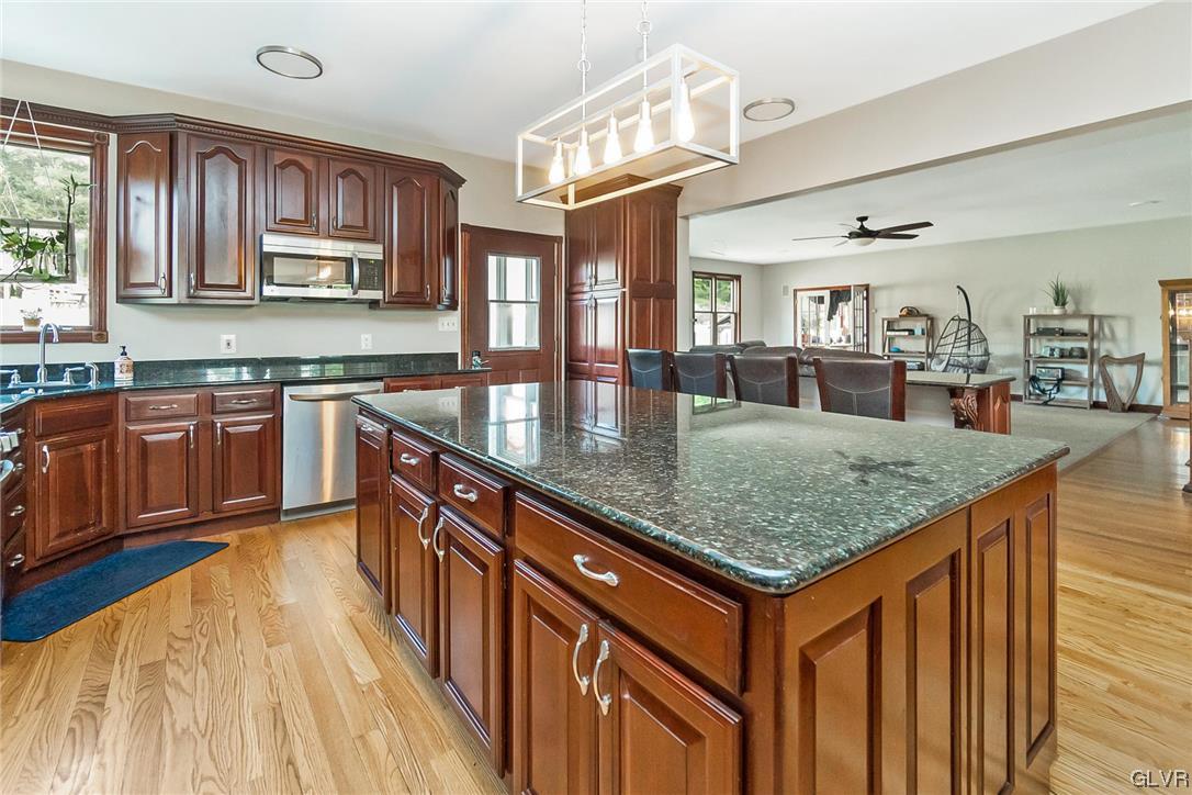 870 Stagecoach Road West Lehighton, PA 18235 - Photo 23 of 50 a kitchen with stainless steel appliances granite countertop a sink dishwasher and cabinets with wooden floor