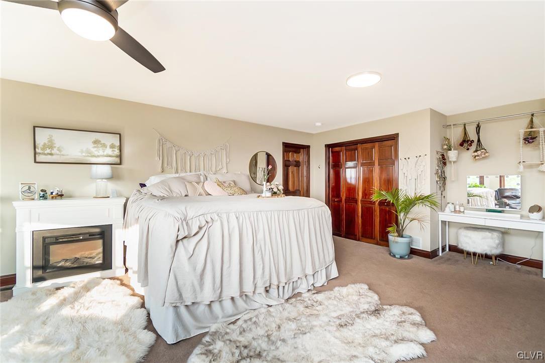 870 Stagecoach Road West Lehighton, PA 18235 - Photo 33 of 50 a spacious bedroom with a bed and a fireplace