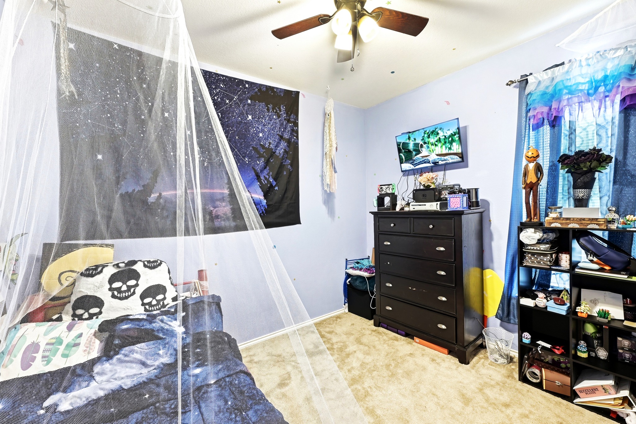 1621 Dragonfly Loop Bastrop, TX 78602 - Photo 19 of 27 Carpeted room with light blue walls featuring a ceiling fan with integrated lighting