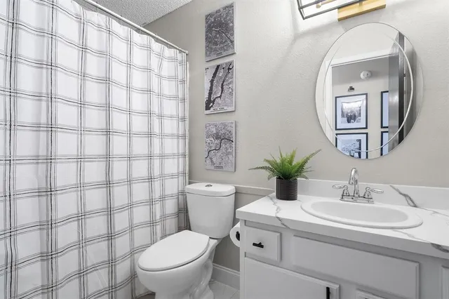 a bathroom with a sink toilet and a mirror