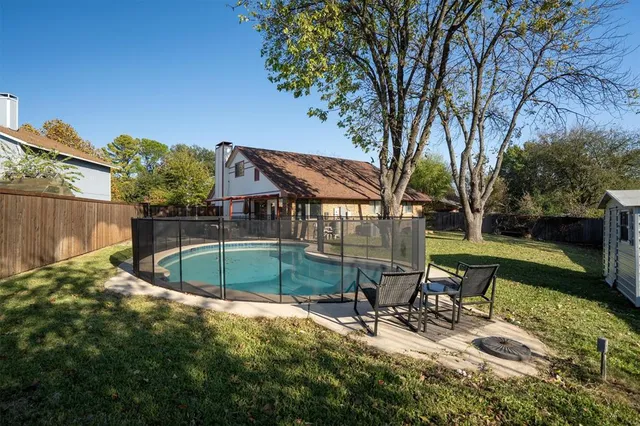 a view of a backyard with a patio and outdoor seating