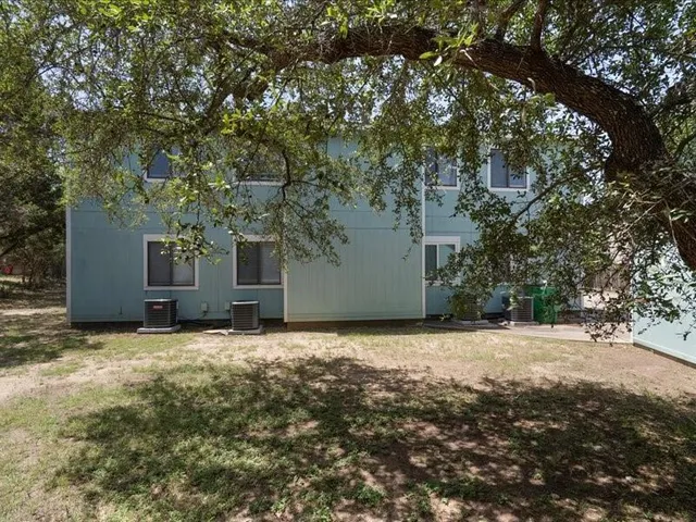 a view of a yard with large trees