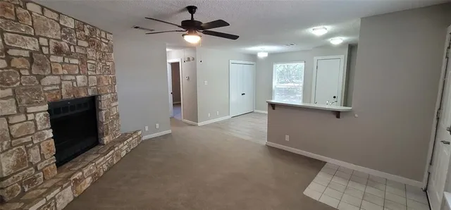 wooden floor in an empty room with a fireplace