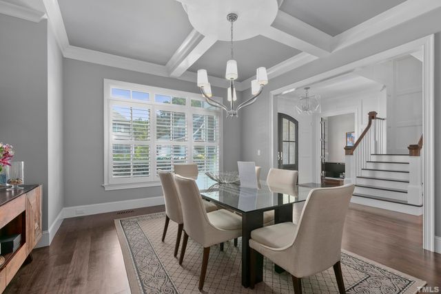 a view of a dining room with furniture wooden floor and chandelier