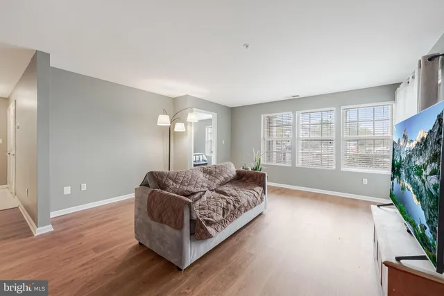 a spacious bedroom with a bed and a large window