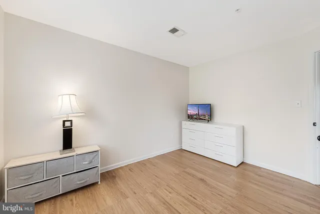 a view of an empty room and wooden floor