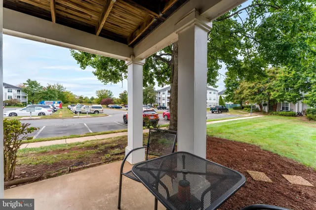 a view of a patio with a table chairs and a yard
