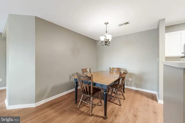 a view of a dining room with furniture and chandelier
