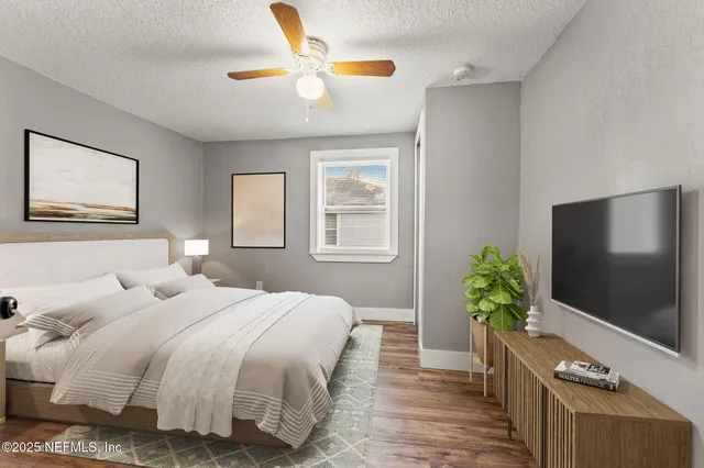 a bedroom with a bed and a flat screen tv