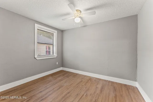a view of a backyard with large trees