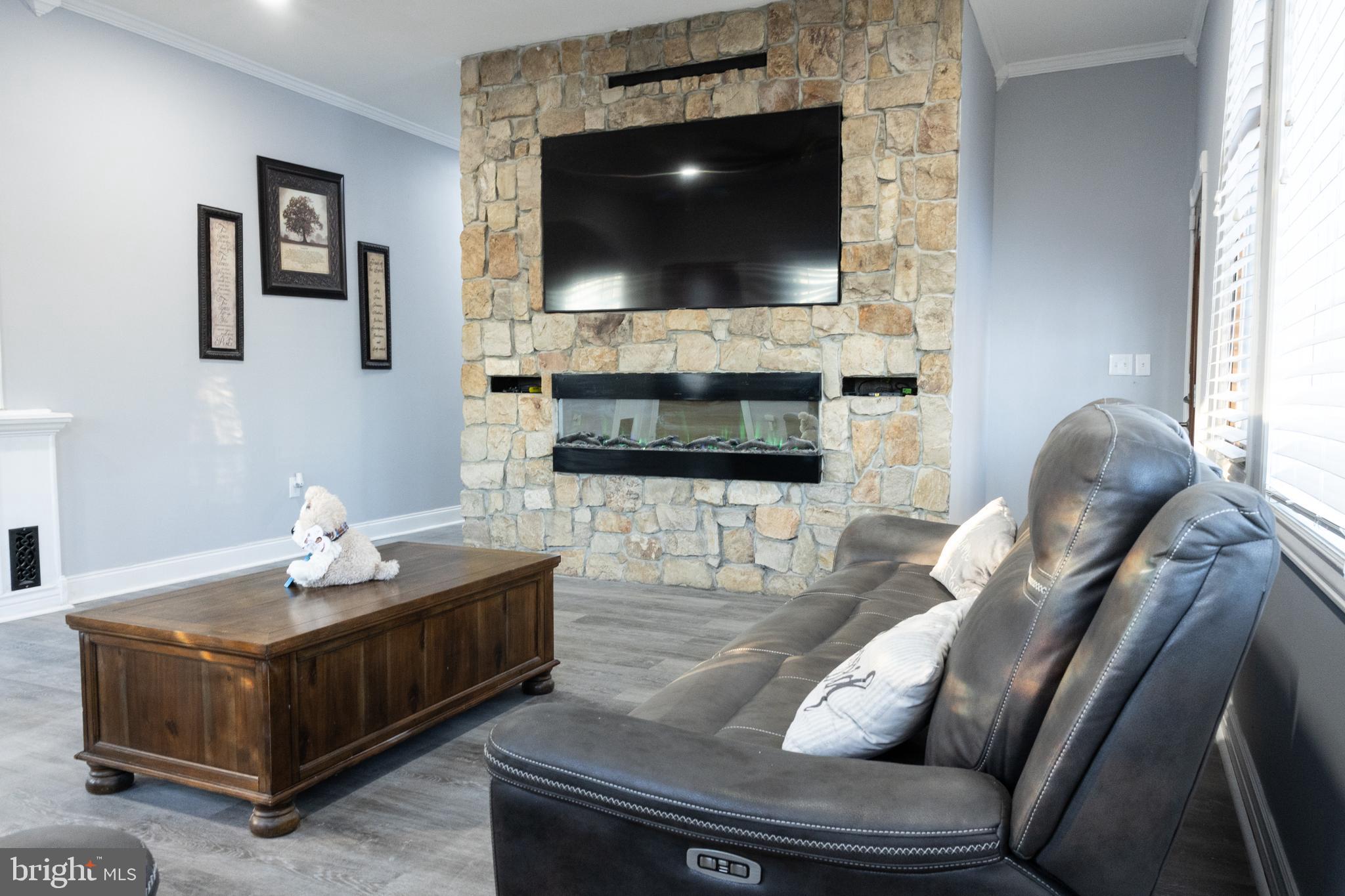 1476 South Orchard Road Vineland, NJ 08360 - Photo 16 of 37 a living room with furniture a flat screen tv and a fireplace