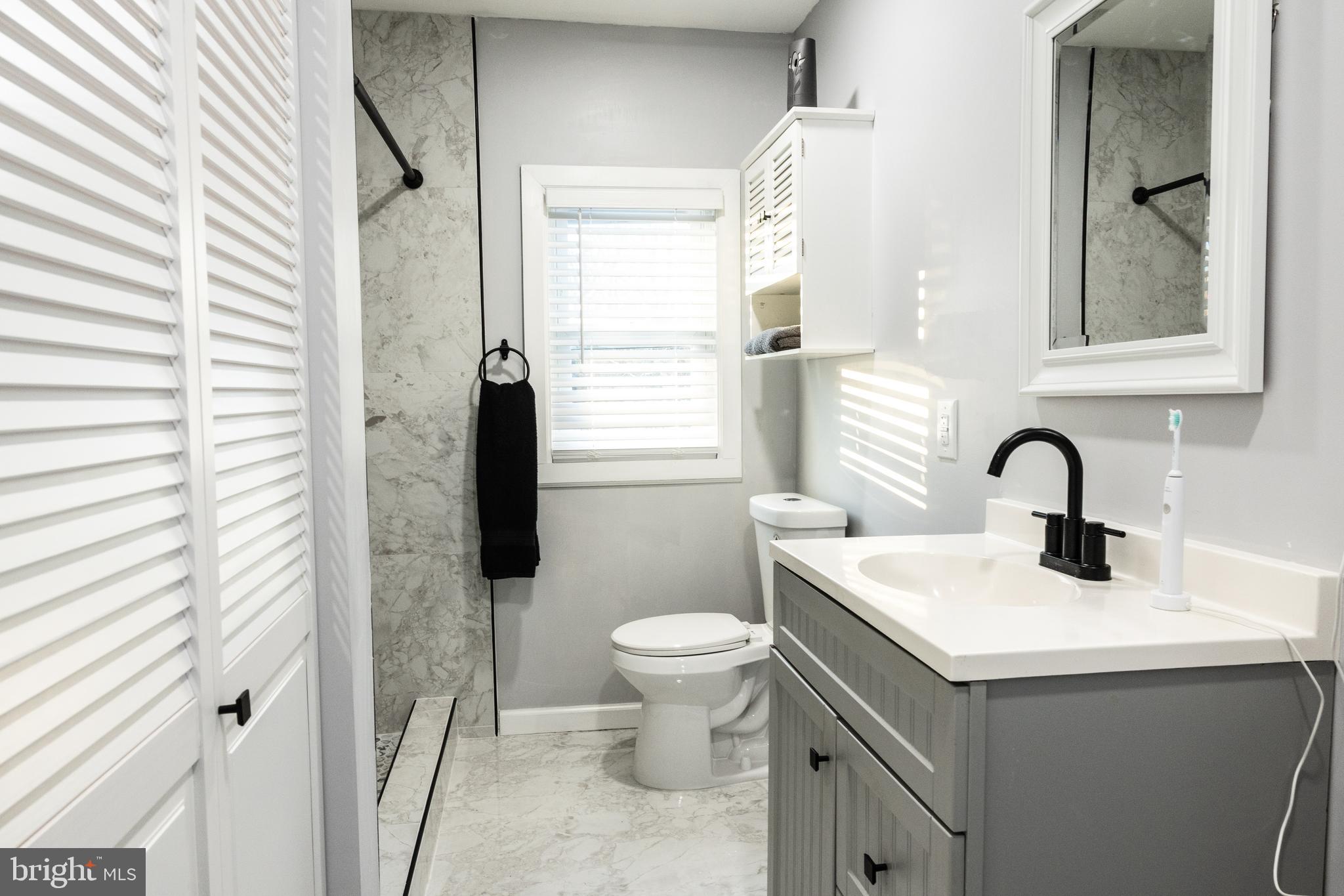 1476 South Orchard Road Vineland, NJ 08360 - Photo 22 of 37 a bathroom with a sink toilet and a window