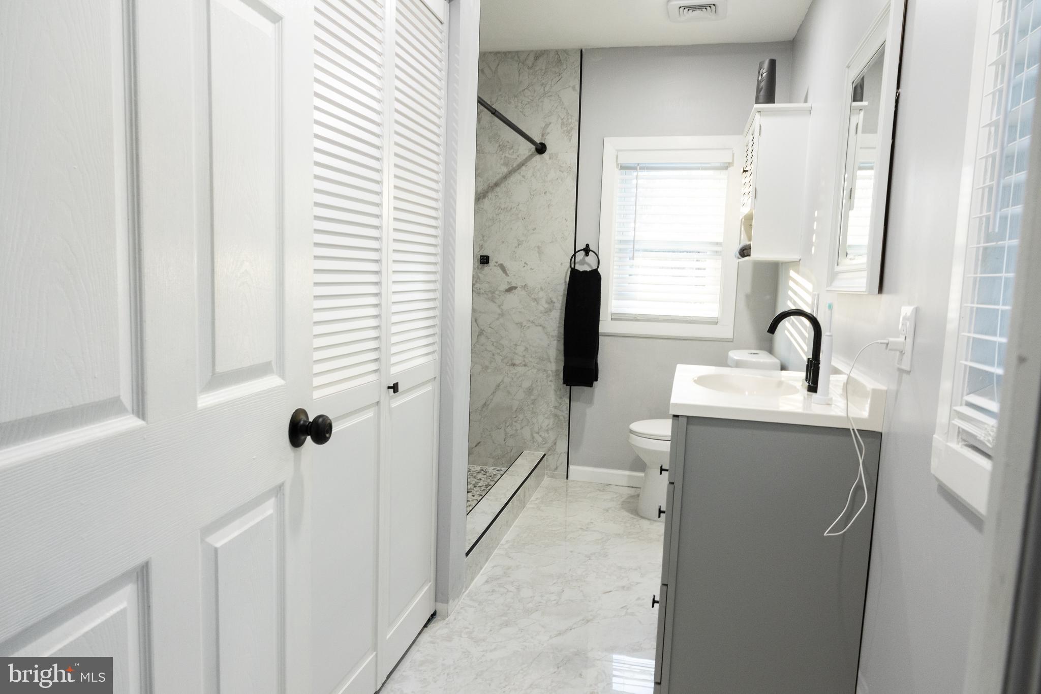 1476 South Orchard Road Vineland, NJ 08360 - Photo 23 of 37 a bathroom with a sink a toilet and shower