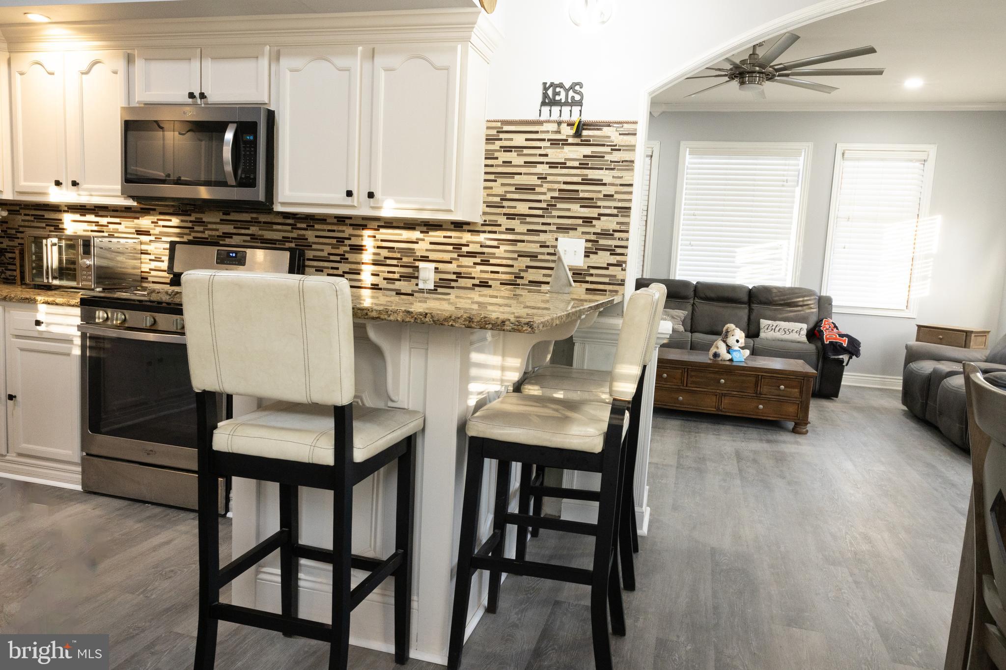 1476 South Orchard Road Vineland, NJ 08360 - Photo 7 of 37 a kitchen with a table chairs microwave and cabinets