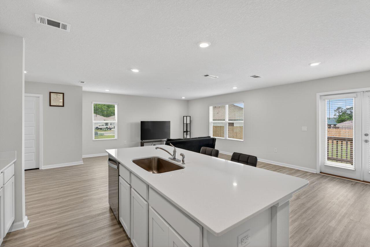 2637 Saltgrass Way Crestview, FL 32536 - Photo 14 of 47 a kitchen with a appliances a sink and a refrigerator