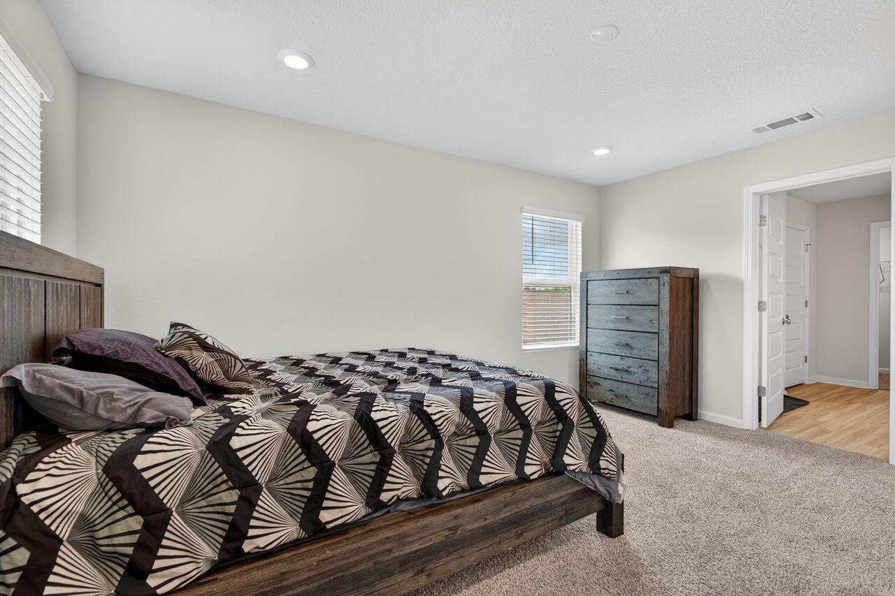 2637 Saltgrass Way Crestview, FL 32536 - Photo 19 of 47 a bedroom with a bed and walk in closet