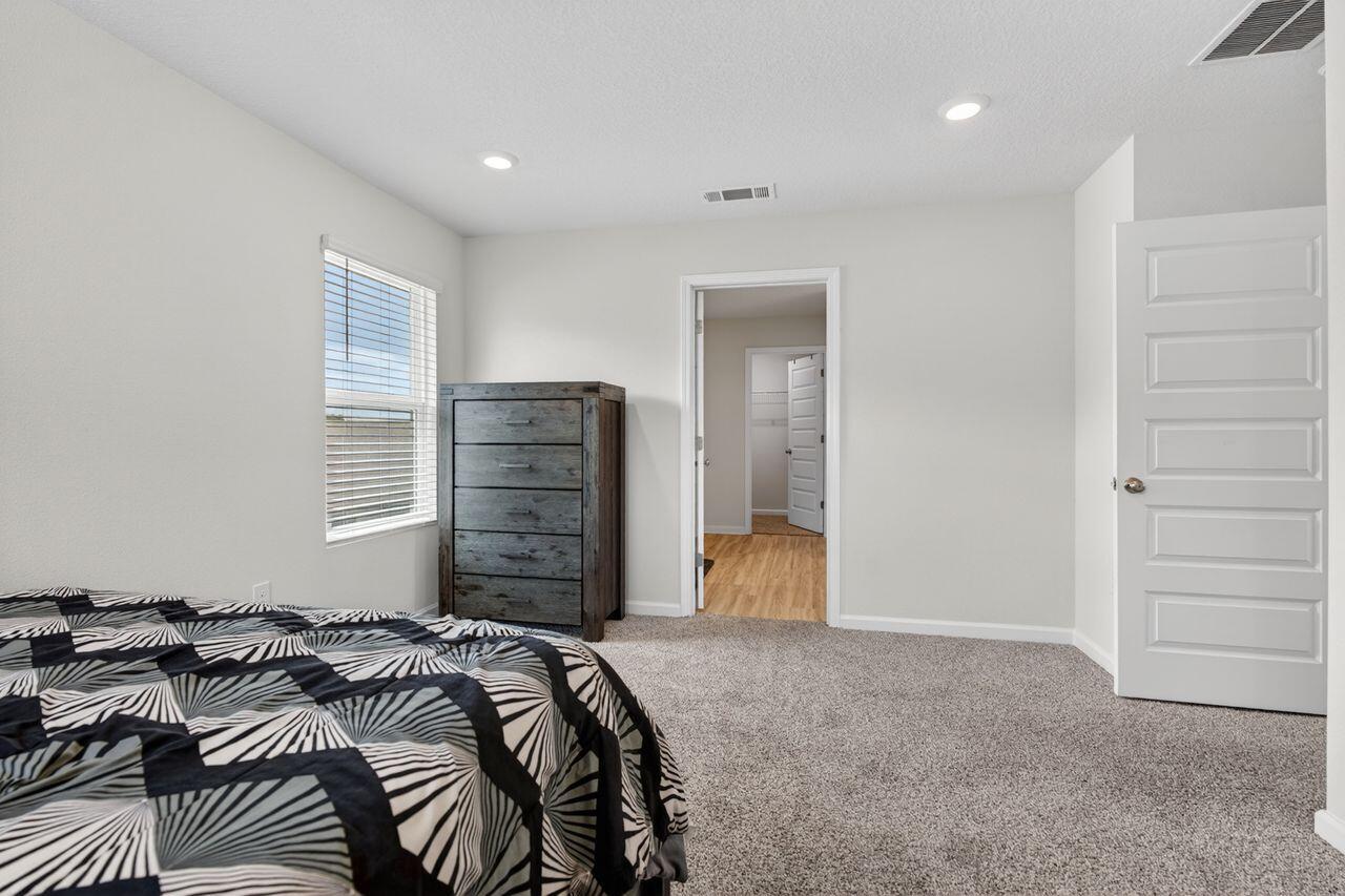 2637 Saltgrass Way Crestview, FL 32536 - Photo 20 of 47 a bedroom with a bed and a walk in closet