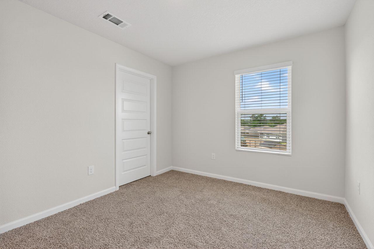 2637 Saltgrass Way Crestview, FL 32536 - Photo 28 of 47 an empty room with windows