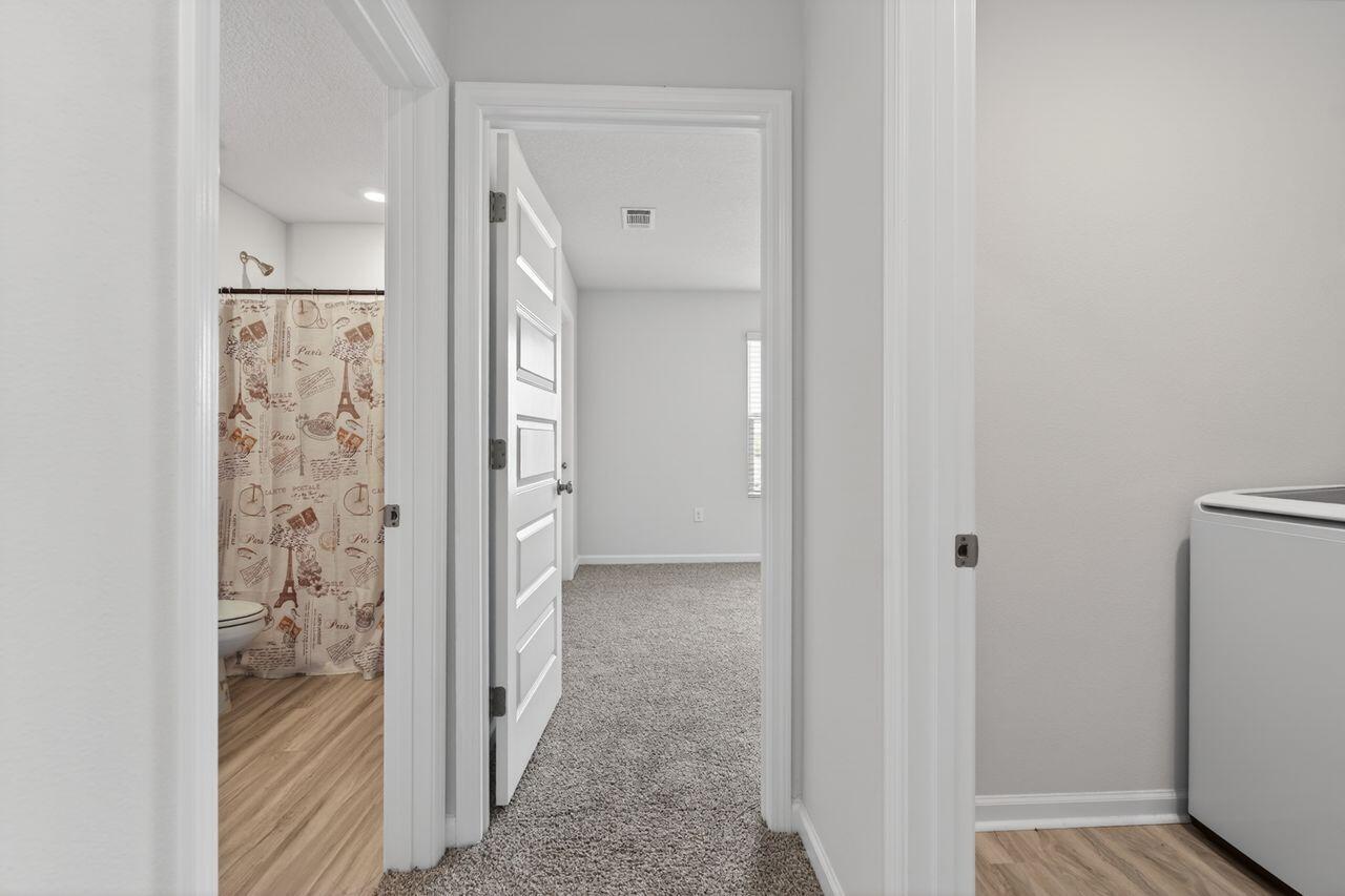 2637 Saltgrass Way Crestview, FL 32536 - Photo 29 of 47 a view of a hallway with wooden shelves