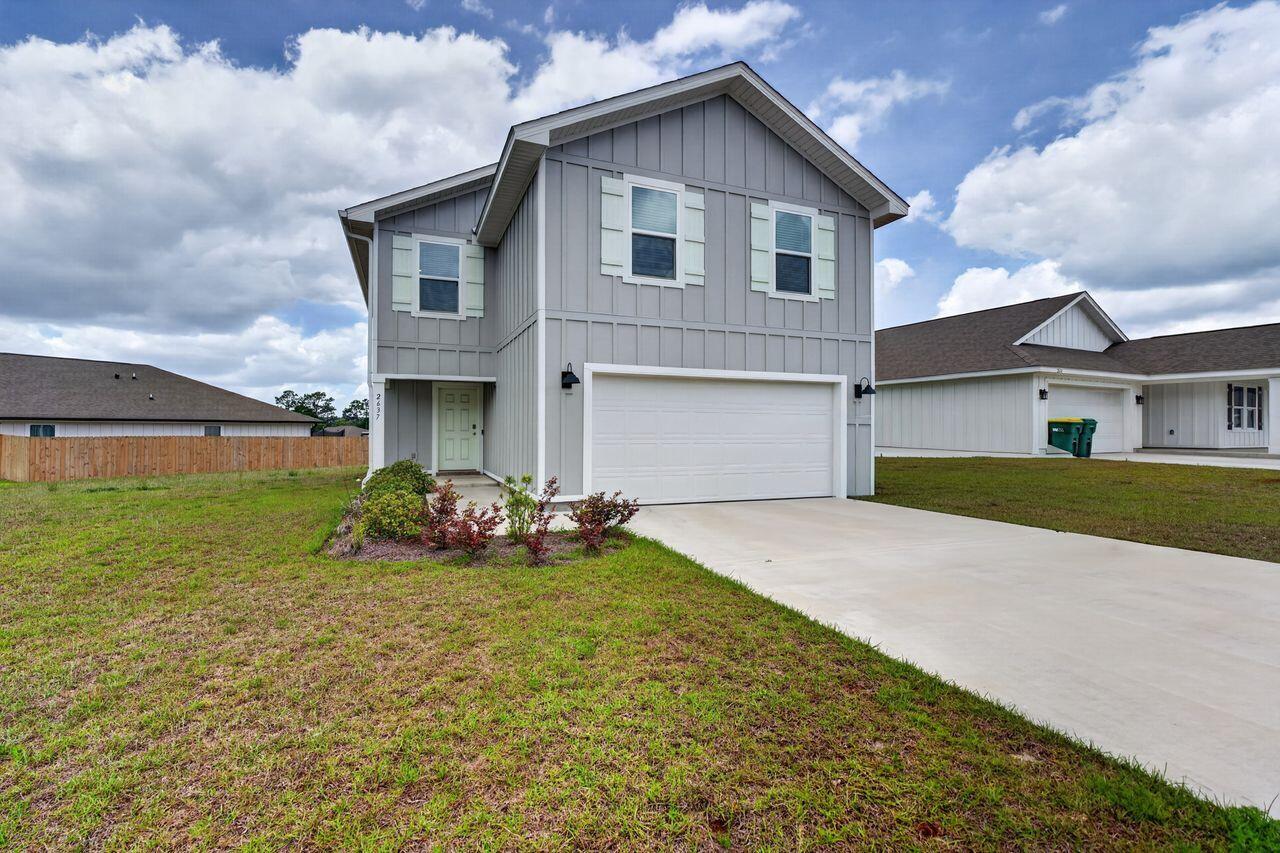 2637 Saltgrass Way Crestview, FL 32536 - Photo 3 of 47 a front view of house with yard and green space