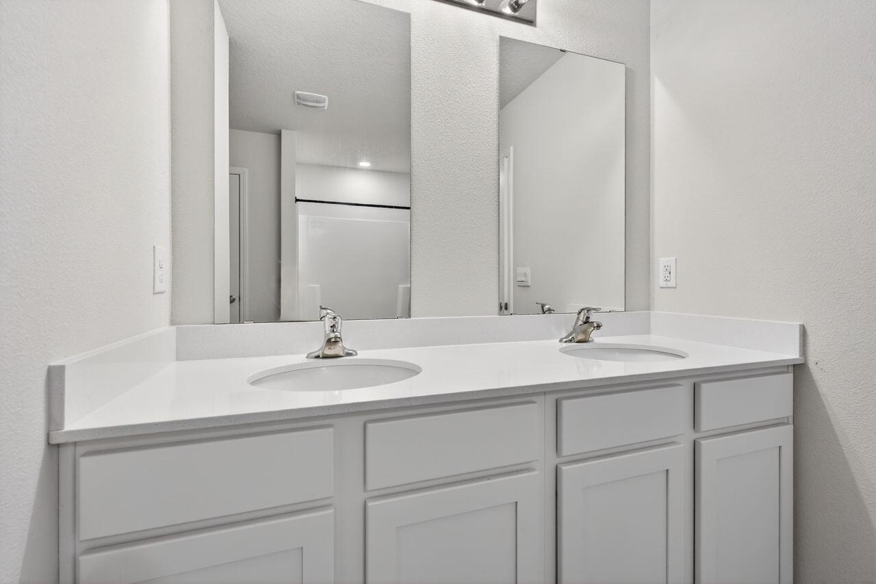 2637 Saltgrass Way Crestview, FL 32536 - Photo 31 of 47 a bathroom with a sink and a mirror