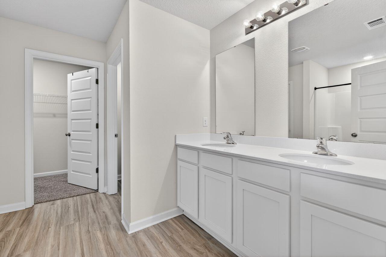 2637 Saltgrass Way Crestview, FL 32536 - Photo 33 of 47 a bathroom with a double vanity sink and mirror