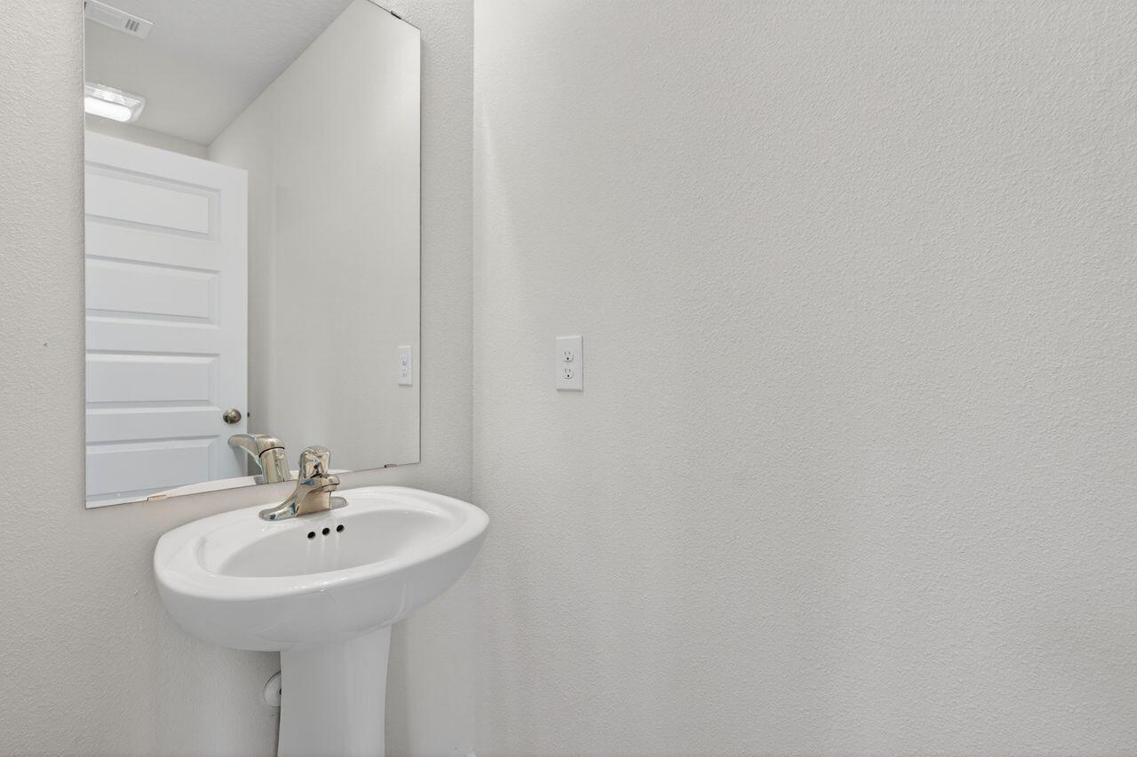 2637 Saltgrass Way Crestview, FL 32536 - Photo 37 of 47 a bathroom with a sink and a mirror