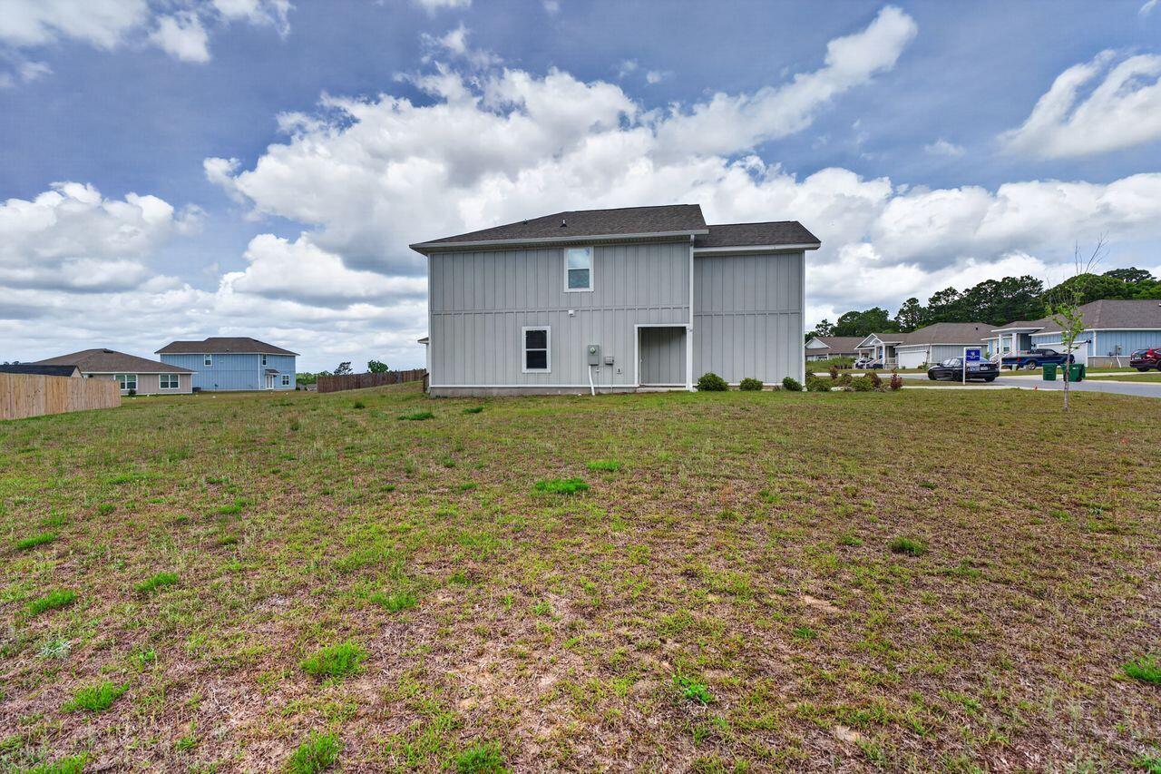 2637 Saltgrass Way Crestview, FL 32536 - Photo 40 of 47 a view of a lake with table and chairs