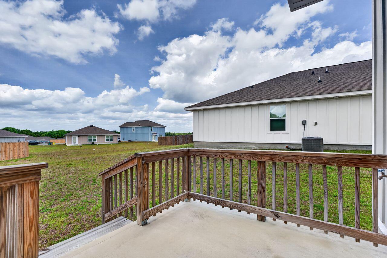 2637 Saltgrass Way Crestview, FL 32536 - Photo 43 of 47 a view of a house with a wooden floor and a yard