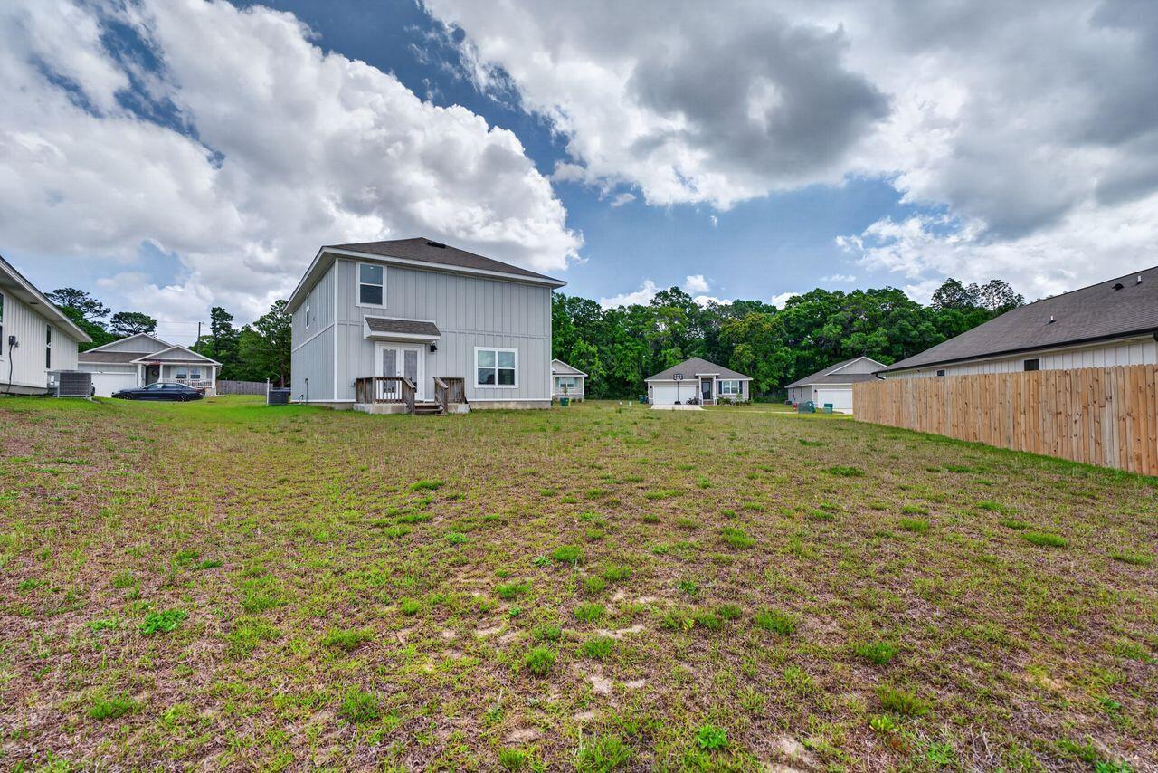 2637 Saltgrass Way Crestview, FL 32536 - Photo 44 of 47 a view of a house with a yard