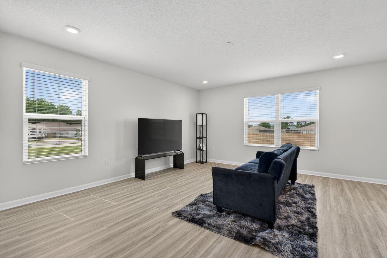 2637 Saltgrass Way Crestview, FL 32536 - Photo 7 of 47 a living room with furniture and a flat screen tv