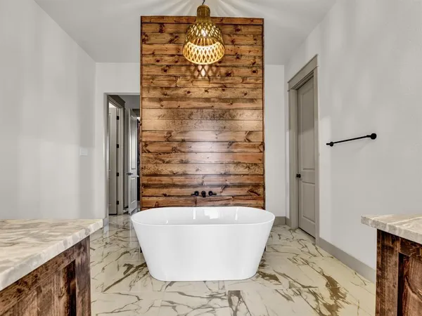 a bathroom with a bathtub and shower