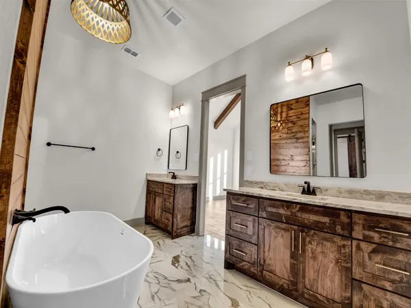 a bathroom with a double vanity sink and a bathtub