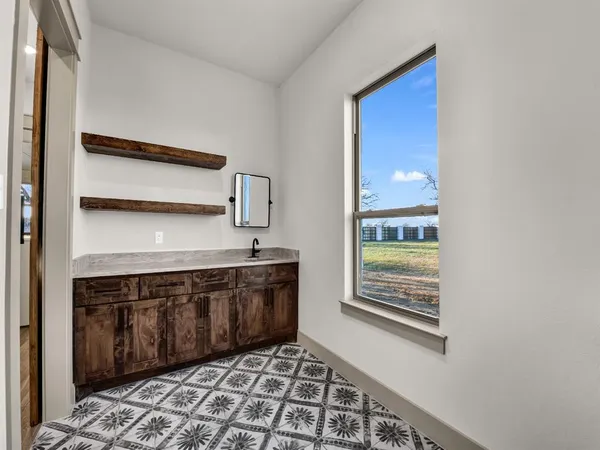 a kitchen with a sink stove and cabinets