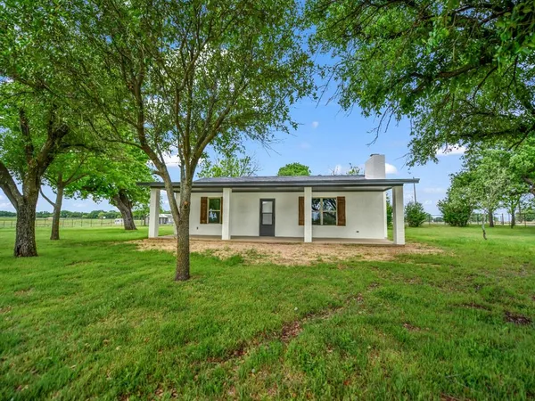 a front view of house with yard and green space