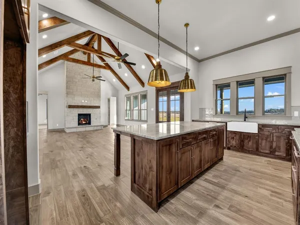 a kitchen with stainless steel appliances granite countertop a sink and wooden floor