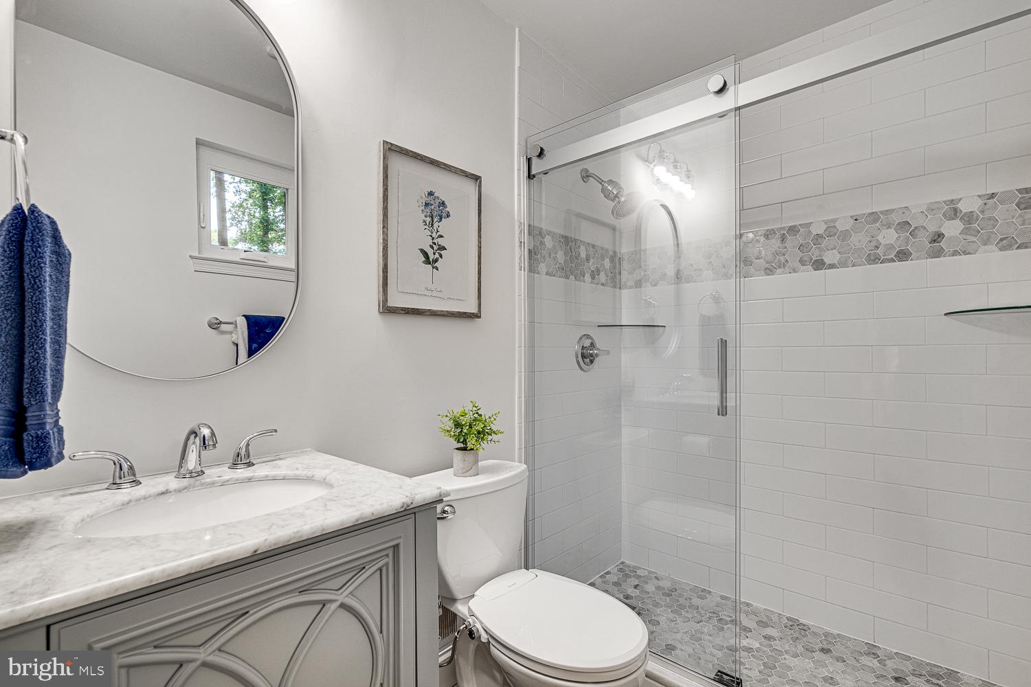 10197 Wavell Road Fairfax, VA 22032 - Photo 23 of 47 a bathroom with a granite countertop sink toilet a shower and a mirror