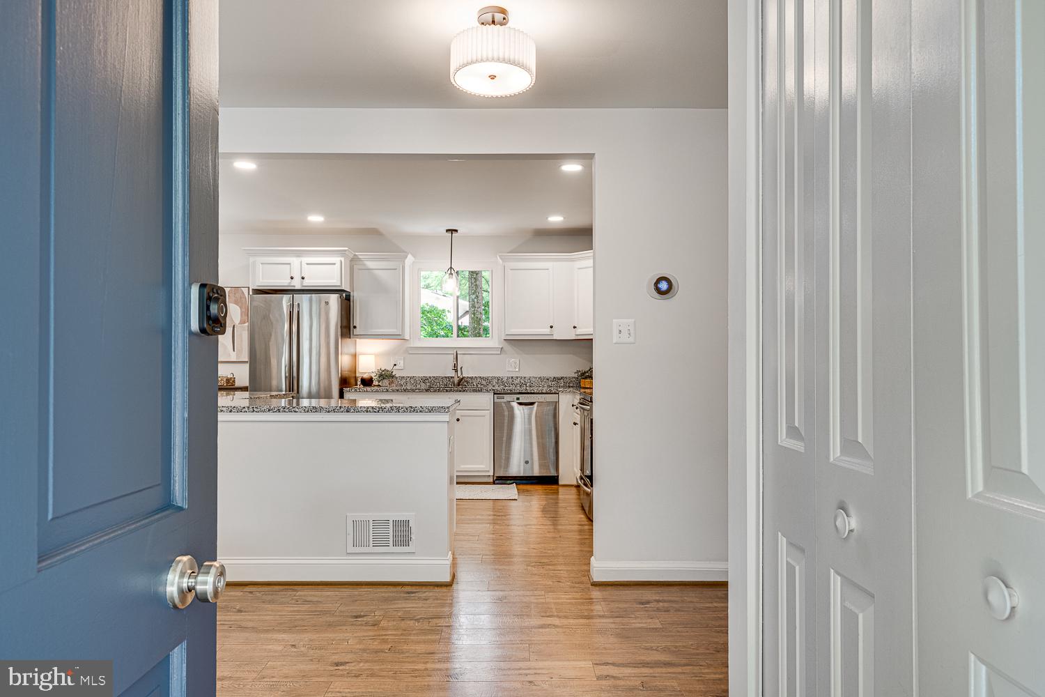 10197 Wavell Road Fairfax, VA 22032 - Photo 4 of 47 a kitchen with stainless steel appliances kitchen island granite countertop a refrigerator and a sink