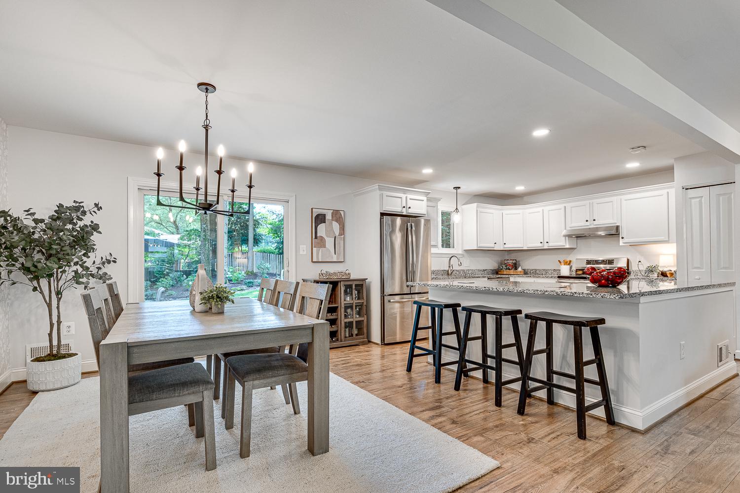 10197 Wavell Road Fairfax, VA 22032 - Photo 9 of 47 a kitchen with kitchen island a table and chairs in it