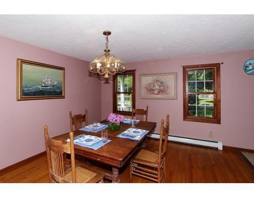 8 Knoll Top Road Sandwich, MA 02644 - Photo 12 of 25 a dining room with chandelier and wooden floor