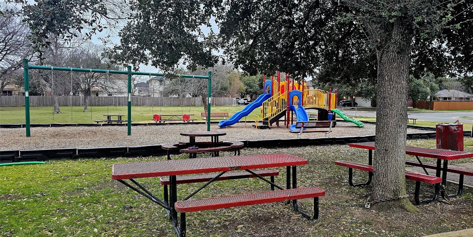 1840 Wallin Loop Round Rock, TX 78664 - Photo 3 of 17 a view of park with swings and slides