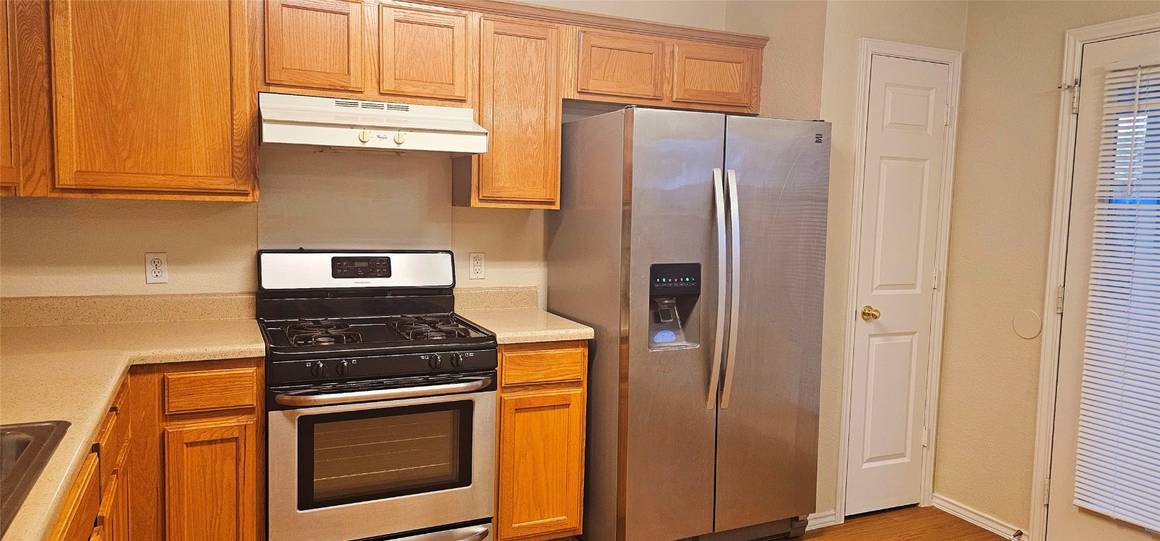 1840 Wallin Loop Round Rock, TX 78664 - Photo 7 of 17 a kitchen with stainless steel appliances granite countertop a refrigerator and a stove top oven